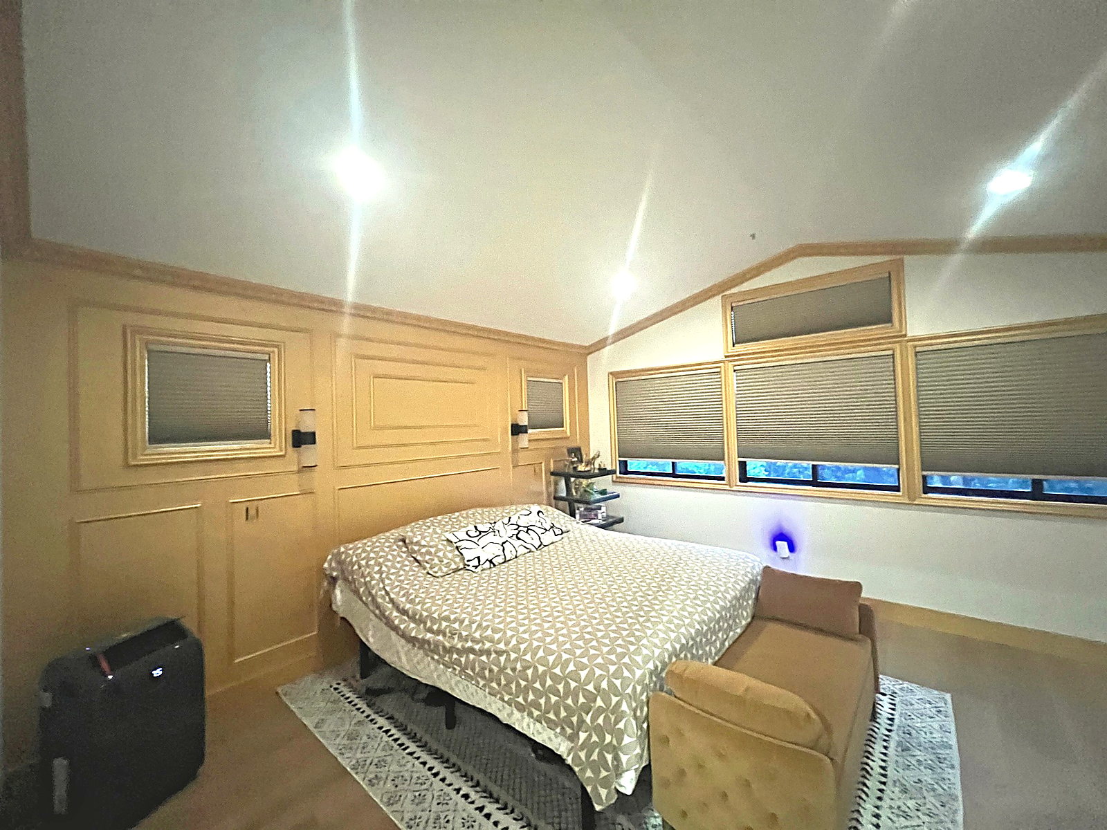 Bedroom featuring custom wood trim, recessed lighting, and detailed wall panel work.