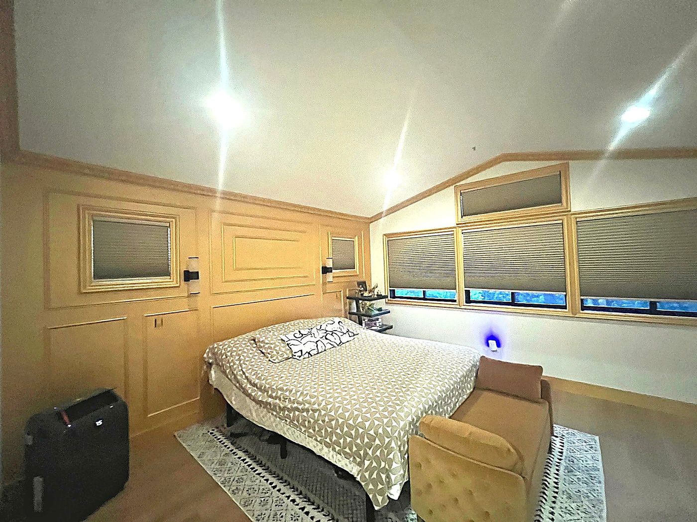 Bedroom featuring custom wood trim, recessed lighting, and detailed wall panel work.